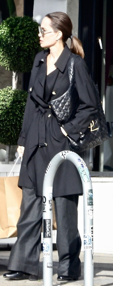 Who made Angelina Jolie's black belted coat and leather handbag